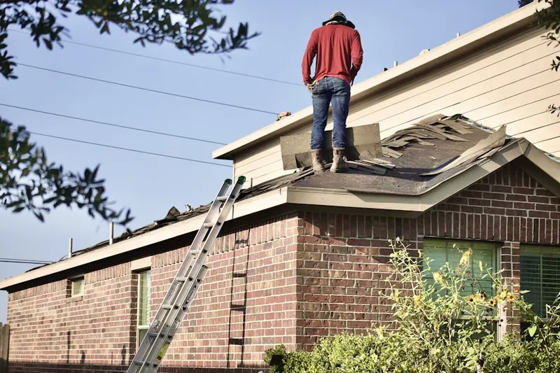 Professional roofer working on a residential roof in Traymore